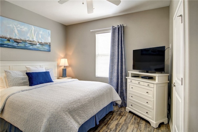 bedroom with dark hardwood / wood-style floors and ceiling fan