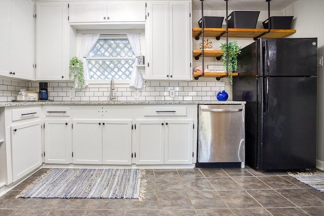 kitchen featuring black fridge, white cabinets, dishwasher, and light stone countertops