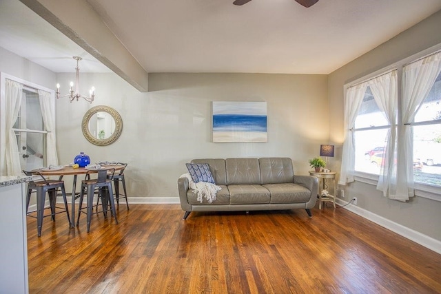 living room featuring an inviting chandelier and dark hardwood / wood-style floors