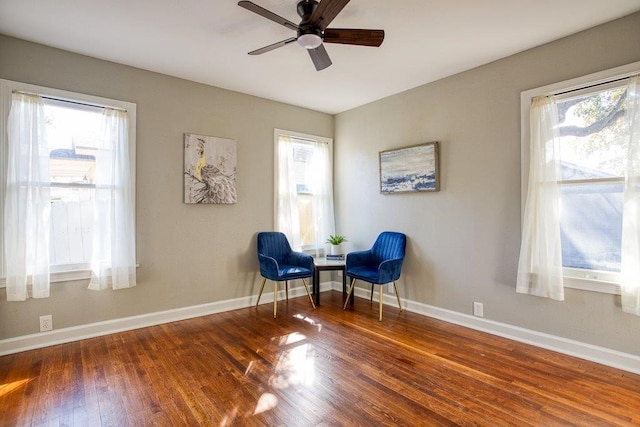 sitting room featuring ceiling fan and dark hardwood / wood-style flooring