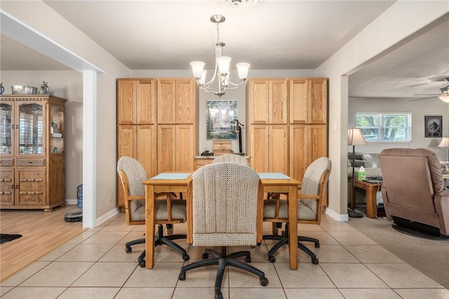 314 Inglewood, Ingleside, TX 78362 - dining area featuring light tile patterned flooring, ceiling fan with notable chandelier, and baseboards