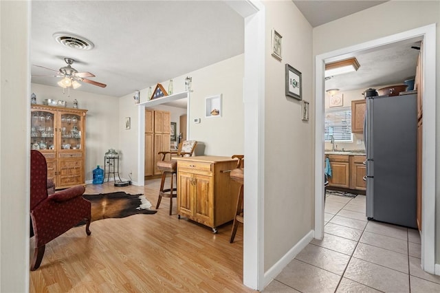 314 Inglewood, Ingleside, TX 78362 - corridor featuring light wood-type flooring, baseboards, visible vents, and a sink
