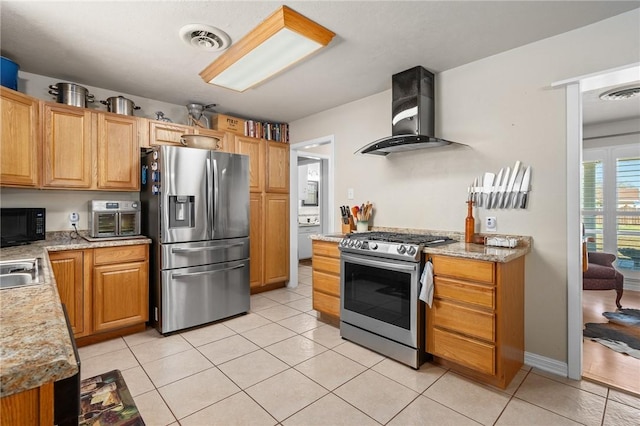 314 Inglewood, Ingleside, TX 78362 - kitchen with light tile patterned floors, stainless steel appliances, visible vents, and wall chimney exhaust hood