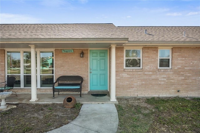 314 Inglewood, Ingleside, TX 78362 - view of exterior entry with brick siding and a shingled roof