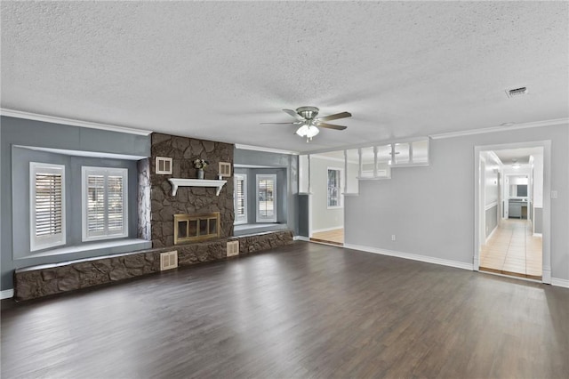 unfurnished living room featuring ornamental molding, wood finished floors, visible vents, and ceiling fan