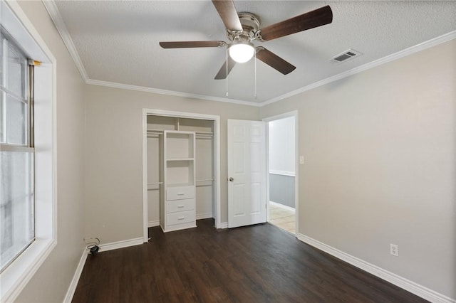 unfurnished bedroom with visible vents, a textured ceiling, a closet, baseboards, and dark wood-style flooring