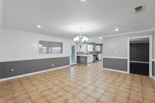 interior space with visible vents, crown molding, recessed lighting, an inviting chandelier, and a sink