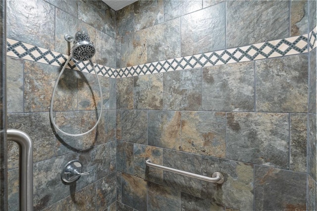 interior details featuring a tile shower