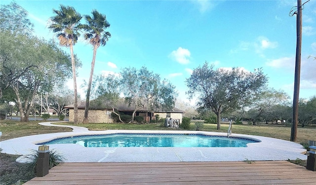 view of swimming pool featuring a lawn