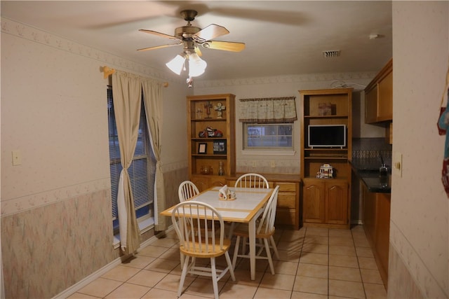 tiled dining area featuring ceiling fan