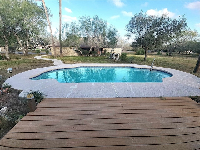 view of pool with a lawn