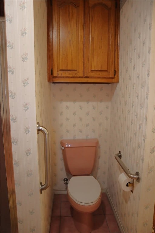 bathroom featuring tile patterned flooring and toilet