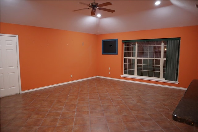 unfurnished room with electric panel, ceiling fan, tile patterned flooring, and vaulted ceiling