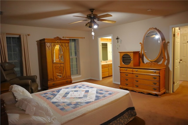 carpeted bedroom with connected bathroom, ceiling fan, and sink