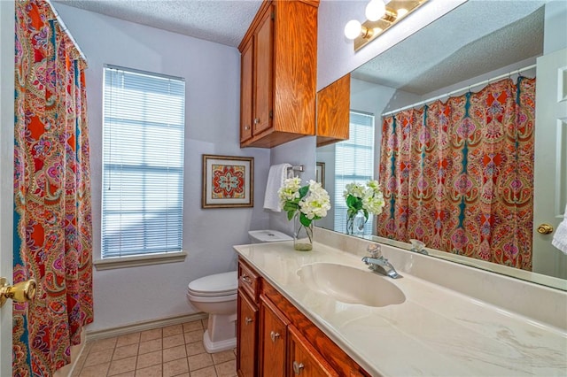 14613 Powell Dr, Corpus Christi, TX 78410 - bathroom with a textured ceiling, vanity, tile patterned floors, and plenty of natural light