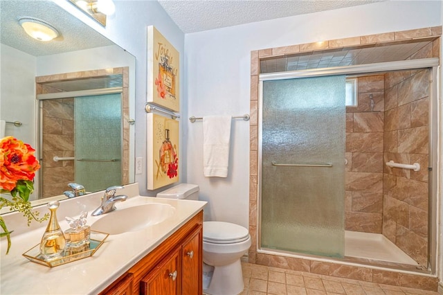 14613 Powell Dr, Corpus Christi, TX 78410 - full bath featuring vanity, a shower stall, tile patterned flooring, and a textured ceiling