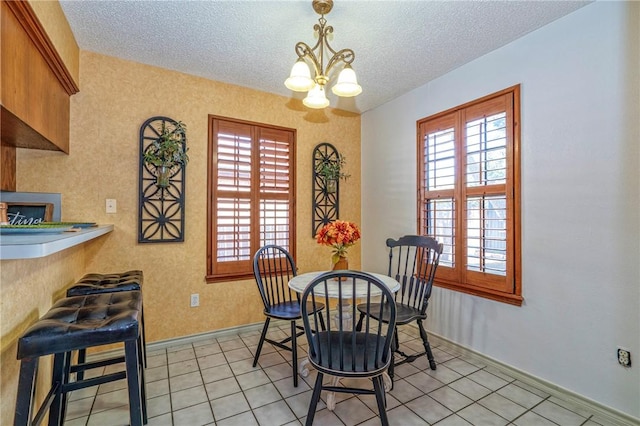 14613 Powell Dr, Corpus Christi, TX 78410 - dining space with a textured ceiling, a chandelier, and light tile patterned flooring