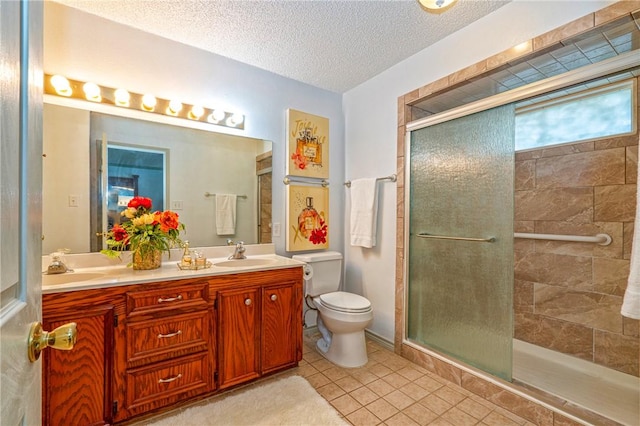 14613 Powell Dr, Corpus Christi, TX 78410 - full bath featuring double vanity, tiled shower, a textured ceiling, and tile patterned floors