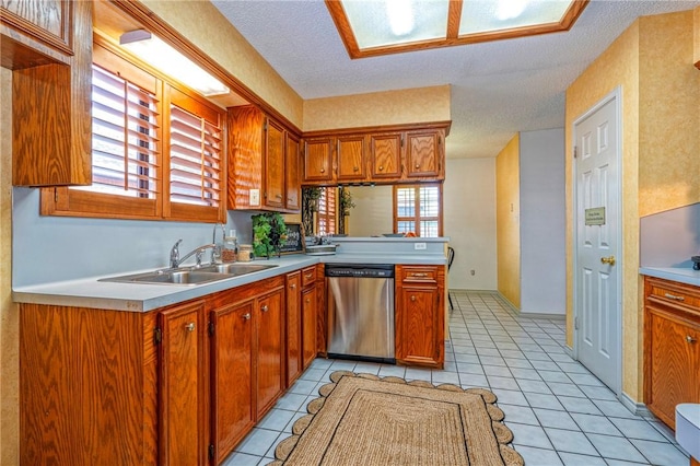 14613 Powell Dr, Corpus Christi, TX 78410 - kitchen with dishwasher, light countertops, light tile patterned flooring, brown cabinetry, and a textured ceiling