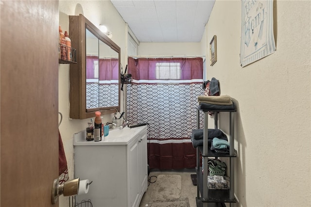 bathroom featuring vanity and curtained shower