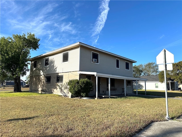 back of property featuring a yard