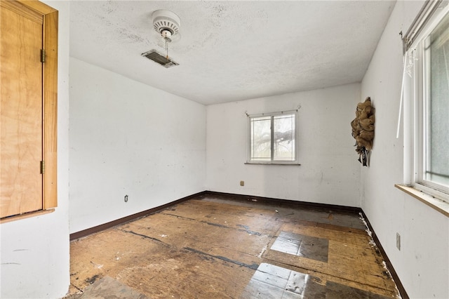 spare room with a textured ceiling