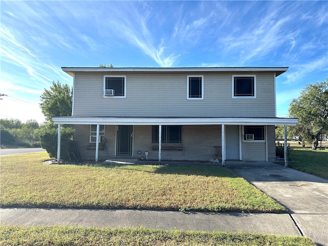 view of front of property featuring a front yard, a carport, and a porch