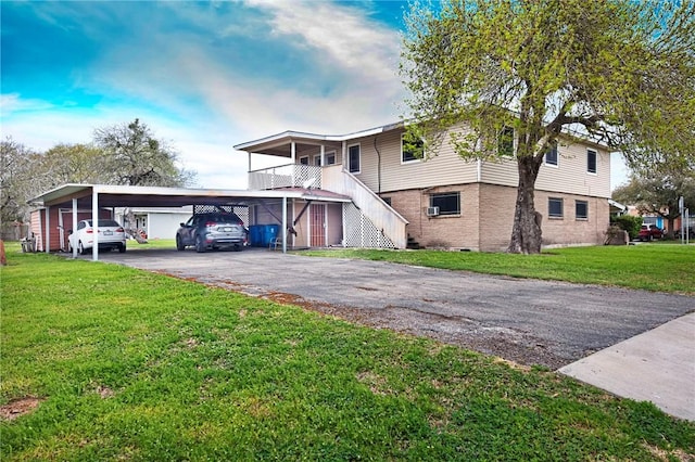 100 Lamplite Ln, Sinton, TX 78387 - view of front of house featuring a carport, driveway, a front lawn, stairs, and brick siding