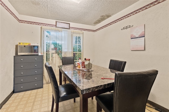 dining space with a textured ceiling