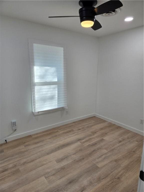 empty room with ceiling fan and light wood-type flooring