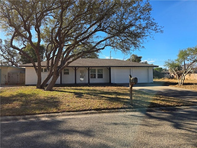 ranch-style house with a garage and a front lawn