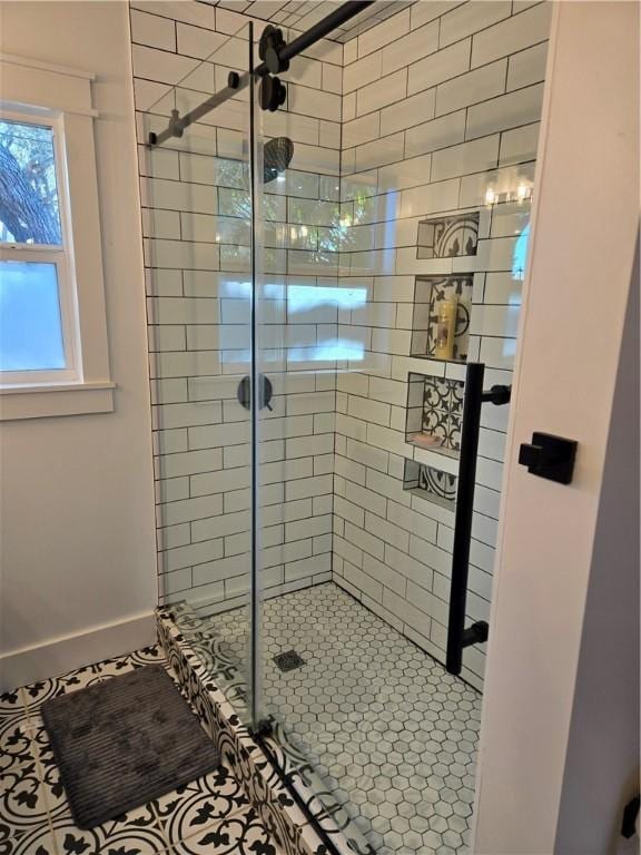 bathroom featuring an enclosed shower and tile patterned floors