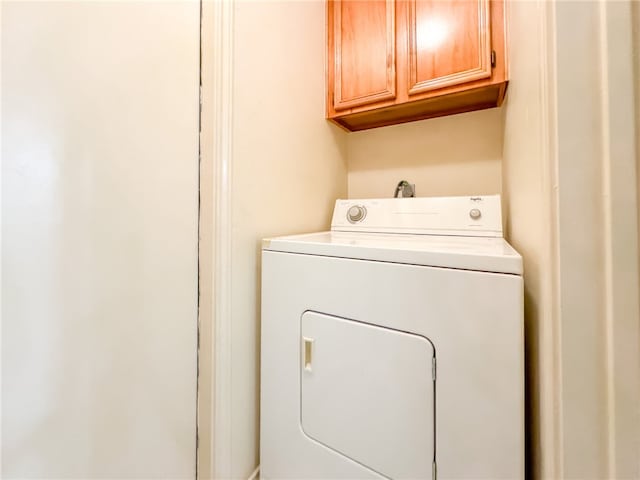 laundry area with cabinets and washer / dryer