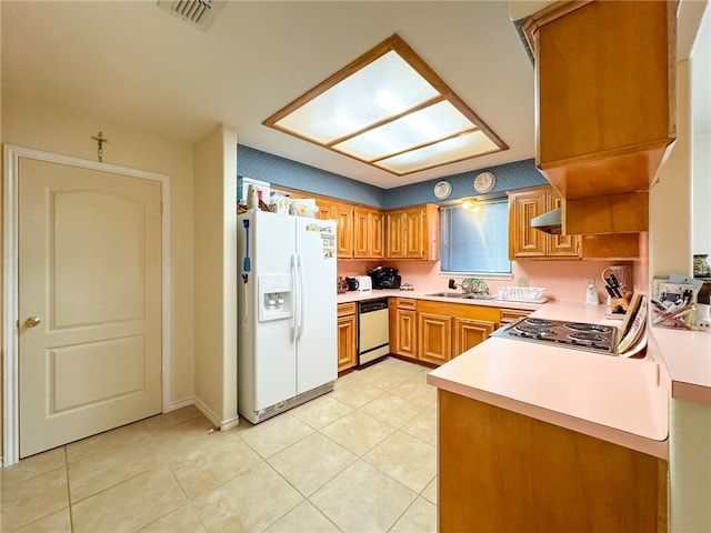 kitchen with stainless steel appliances, kitchen peninsula, sink, light tile patterned floors, and ventilation hood