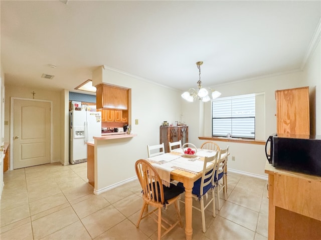 tiled dining area featuring crown molding and a notable chandelier