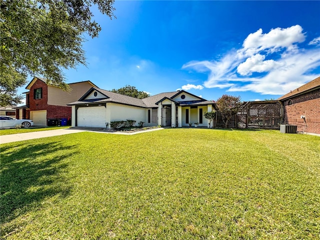 view of front of property with a garage, cooling unit, and a front yard