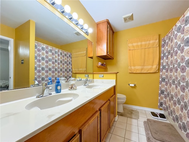 bathroom featuring toilet, vanity, and tile patterned floors