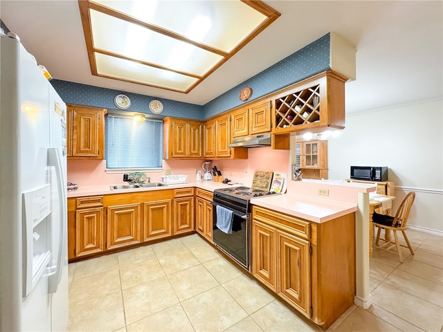 kitchen featuring black appliances, kitchen peninsula, sink, and light tile patterned floors