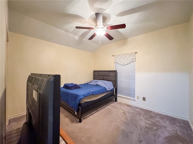 carpeted bedroom with ceiling fan and vaulted ceiling