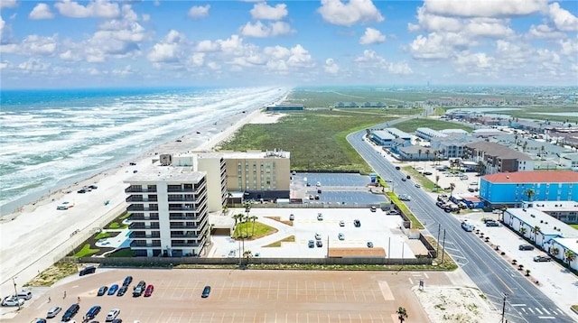 drone / aerial view featuring a view of the beach and a water view