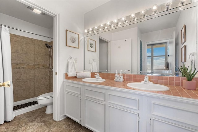 bathroom with walk in shower, vanity, and toilet