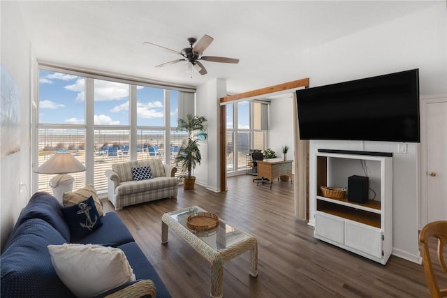 living room featuring floor to ceiling windows, dark hardwood / wood-style floors, and ceiling fan