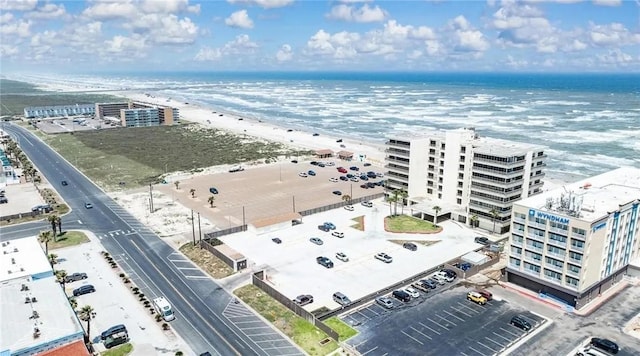 birds eye view of property with a beach view and a water view