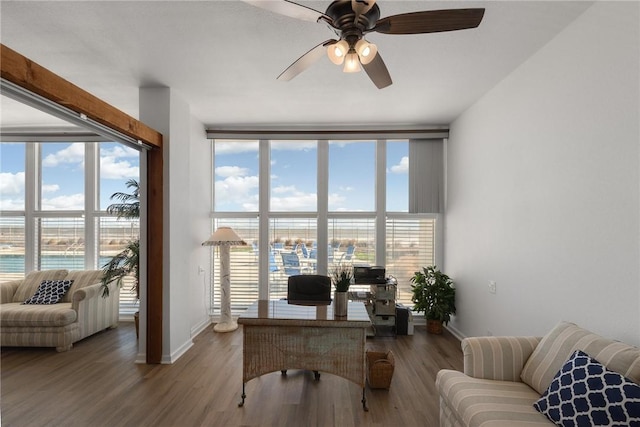 office space featuring hardwood / wood-style flooring, ceiling fan, and a water view