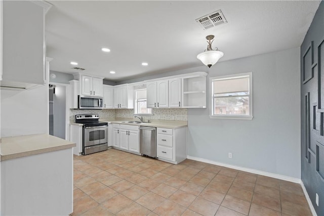 1318 W Cherrystone Dr, Corpus Christi, TX 78412 - kitchen featuring appliances with stainless steel finishes, open shelves, tasteful backsplash, white cabinetry, and recessed lighting