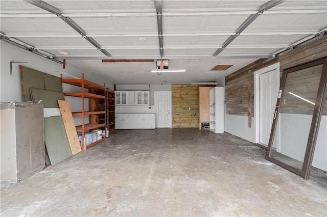 1318 W Cherrystone Dr, Corpus Christi, TX 78412 - garage featuring a garage door opener and wood walls