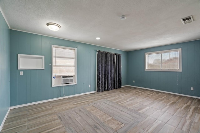 1318 W Cherrystone Dr, Corpus Christi, TX 78412 - unfurnished room featuring a textured ceiling, cooling unit, and wood finished floors