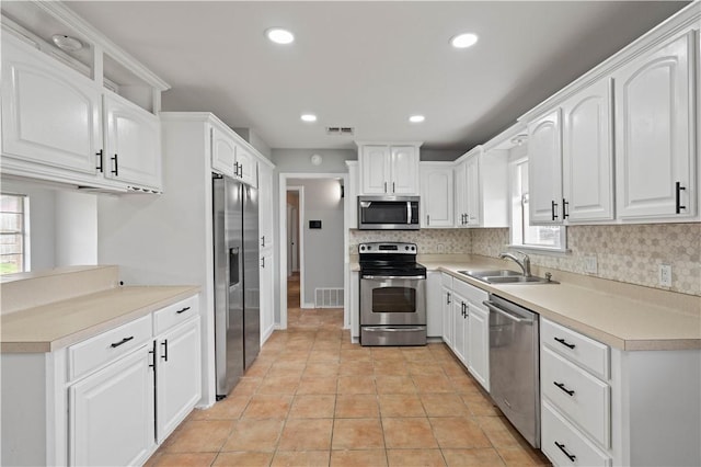 1318 W Cherrystone Dr, Corpus Christi, TX 78412 - kitchen featuring appliances with stainless steel finishes, backsplash, white cabinets, recessed lighting, and light countertops