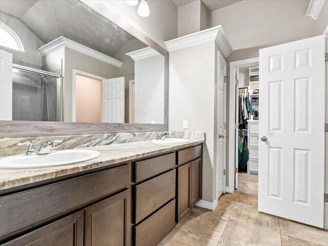 7717 Pruet Dr, Corpus Christi, TX 78414 - full bath with double vanity, a stall shower, a spacious closet, lofted ceiling, and ornamental molding