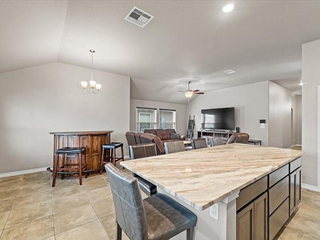 7717 Pruet Dr, Corpus Christi, TX 78414 - kitchen featuring a ceiling fan, lofted ceiling, a kitchen island, a chandelier, and hanging light fixtures